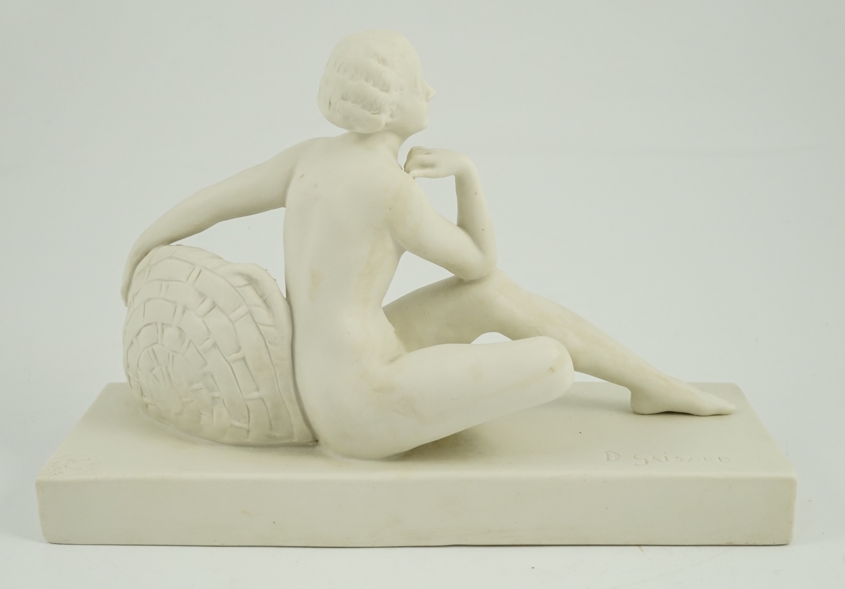 Henri Désiré Grisard (1872 - active until 1940). A signed bisque model of a seated nude by flowers, 1920s